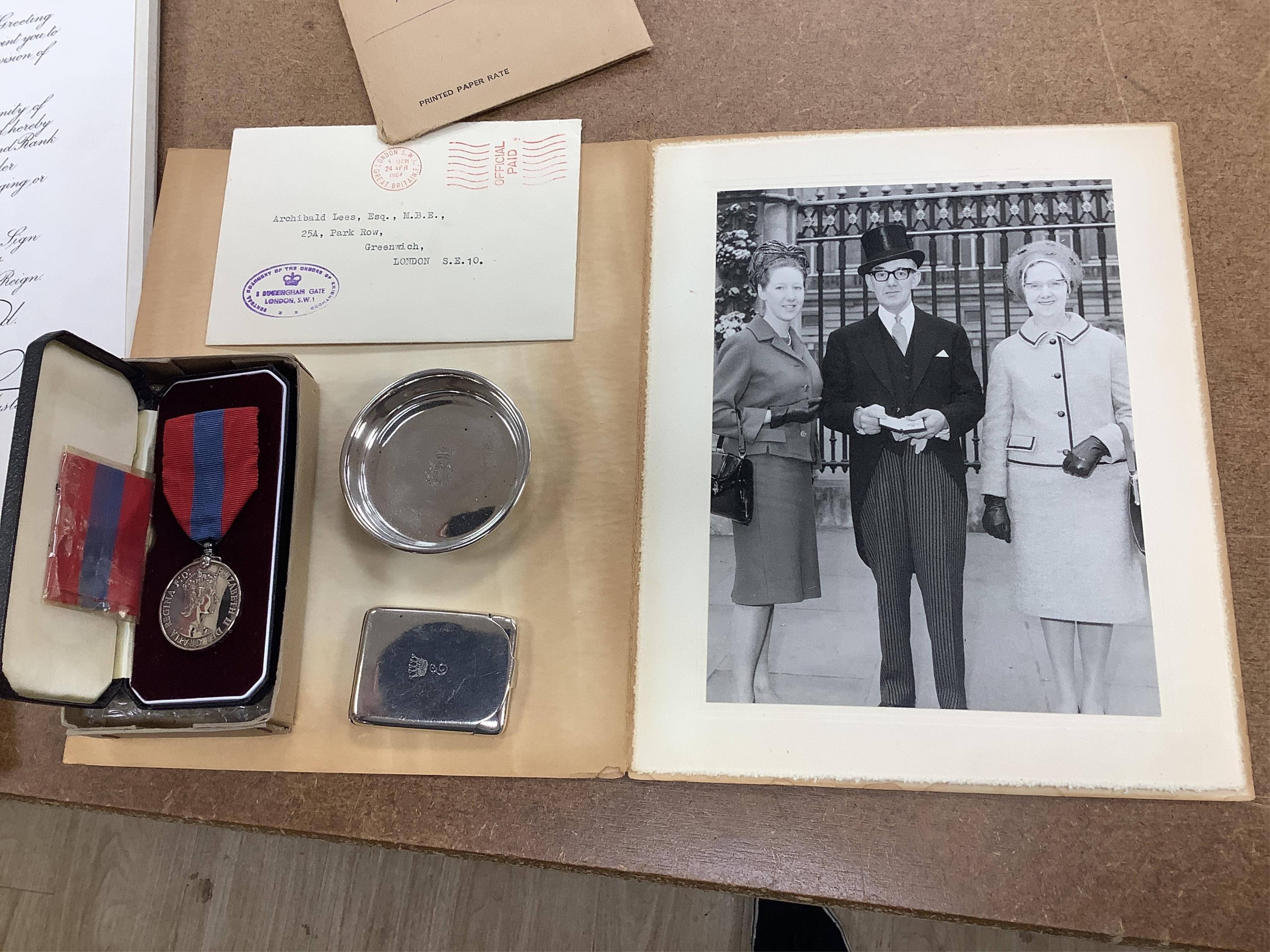 An MBE for Archibald Lees with miniature and an Imperial Service Medal for Thomas Lees, a silver coaster and silver match case with coronet over ‘E’ and ‘Holyrood 1925’ to reverse